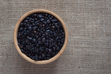 Roasted wild coffee in a wooden bowl.