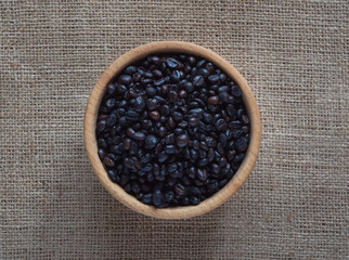 Roasted wild coffee in a wooden bowl.