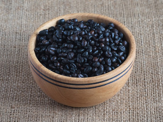 Roasted wild coffee in a wooden bowl.