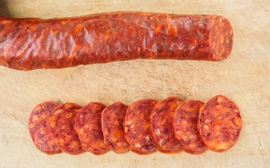 Iberian chorizo, Spanish chorizo ​​or Spanish sausage cut into slices on a wooden board