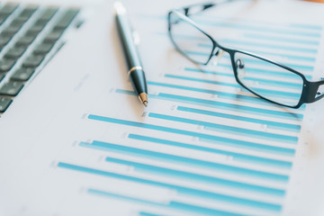 Pile of documents, smartphone and pen. Many graphs and charts. Concept image of data gathering.