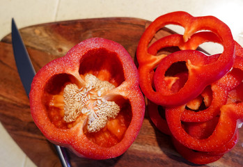 Large ripe pepper Capsicum annuum or sweet red bell pepper sliced. Vegetarian concept. Organic vitamins. Isolated on white background