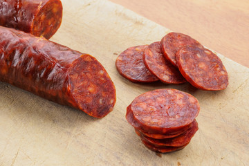 Iberian chorizo, Spanish chorizo ​​or Spanish sausage cut into slices on a wooden board