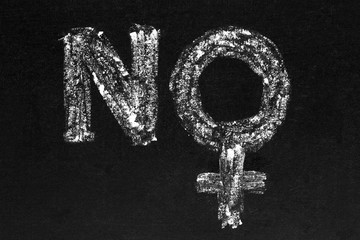NO matriarchy. Handwritten white chalk female sign / symbol on blackboard. Gender wars concept