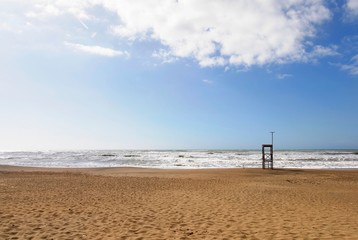 Sand beach with blue sunny sky during mediterranean summer