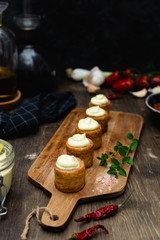 Gourmet dish, spanish appetizer - patatas bravas served on wooden cutting board