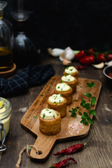 Obraz na płótnie Canvas Gourmet dish, spanish appetizer - patatas bravas served on wooden cutting board