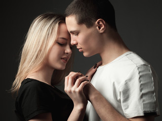 Beautiful young woman and young man in studio.