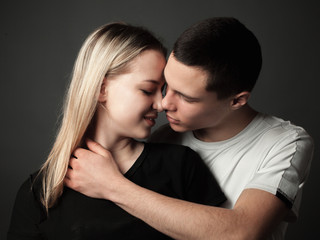 Portrait of young couple in love in studio.