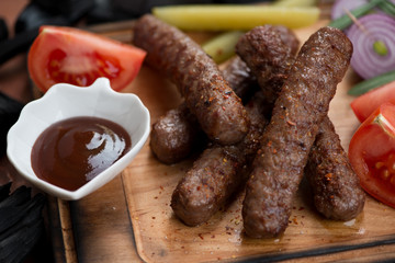 Close-up of grilled balkan cevapi or cevapcici sausages, selective focus, studio shot
