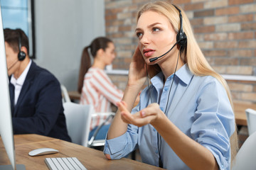 Technical support operator with colleague in modern office