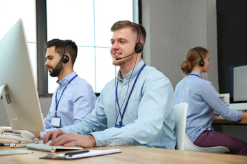 Fototapeta premium Technical support operator working with colleagues in office