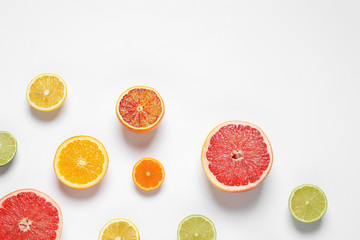 Flat lay composition with different citrus fruits on white background