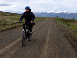 Fototapeta premium man riding a bike on country road