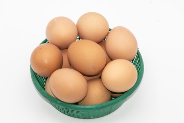 Close up eggs in a green basket isolate on white background. Select focus.