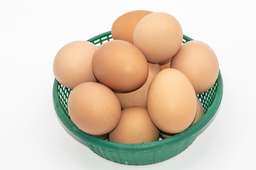 Close up eggs in a green basket isolate on white background. Select focus.