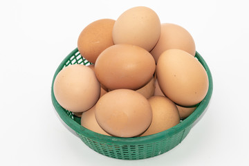 Close up eggs in a green basket isolate on white background. Select focus.