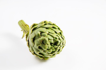 Obraz premium Fresh green Italian Artichoke isolated on white background. Organic local produce vegetable. Vegan diet. Clean eating concept. Close up, top view.