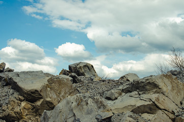 rocks against the blue sky with clouds