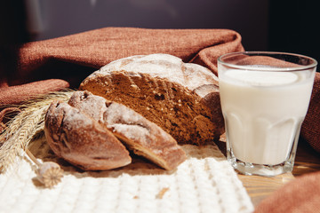 Beautiful breakfast - Loaf of bread with milk or yogurt on table, healthy food