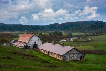 Fototapeta na wymiar country barns in farmland with river and beautiful sky