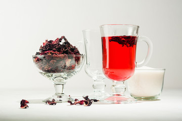 Transparent glass Cup with hot red tea from hibiscus or hibiscus.