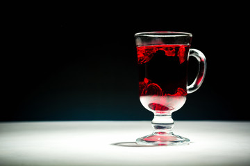 Transparent glass Cup with hot red tea from hibiscus or hibiscus.