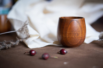 Wooden cup on the brown table