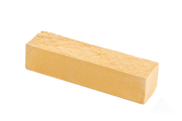 Yellow long relief ceramic brick at the white background, isolated