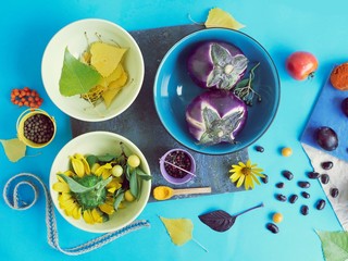 Fresh vegetables, spices, flowers on the table, top view, cooking healthy food, summer