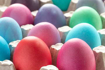 pastel colored easter eggs in a box