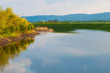 Beautiful lake surrounded by green grass.Lake in nature