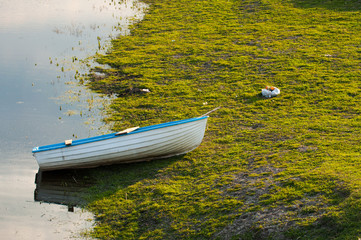 A white blue boat in the water.Boat in lake in nature