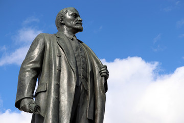 Monument to Lenin against blue sky with white clouds. Vladimir Ulyanov, leader of the russian revolution