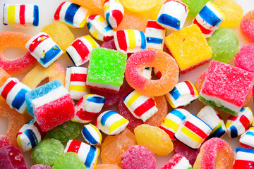 different colored round candy. Top view. Candy background. A lot of colorful candy. Pile of delicious colorful chewing candies as background