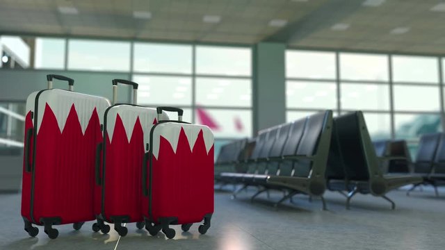 Travel suitcases with flag of Bahrain. Bahraini tourism conceptual animation