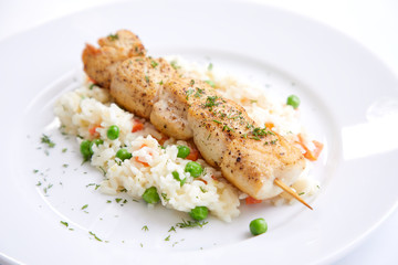 chicken kebab with rice and vegetables on the white background