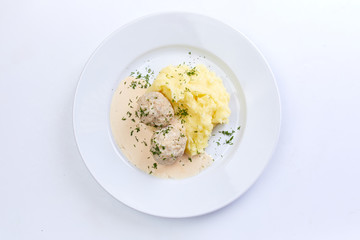 meatballs with mashed potato on the white plate
