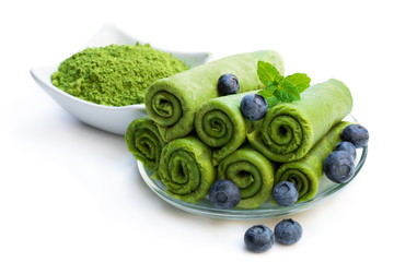 Matcha green tea crepe with blueberry isolated on white