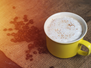 Top view coffee mug with coffee beans. Dark background with copyspace