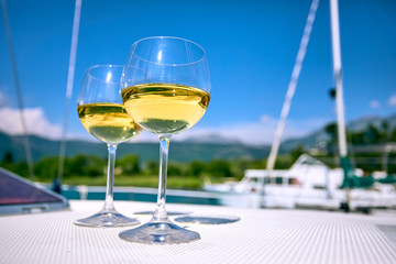 Pair of wineglasses against the yacht