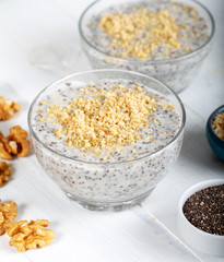 Chia pudding made with milk, banana and decorated with walnut