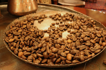 Black coffee beans  in an old copper tray
