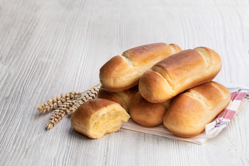 Mini brioche bun in paper bag isolated on white