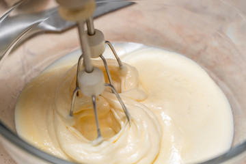 Mixing the ingredients of biscuit dough with an electric mixer