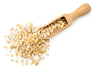 Oat flakes scattered from a wooden spatula on a white. The form of the top.