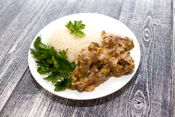 Pork liver with sour cream and rice. Fast diet dish. Healthy food.
