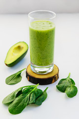 Green spinach and avocado smoothies. Detox drink on white table