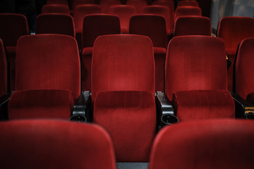 close up photo of rows of red seats in the cinema/theatre/concert 