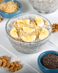 Chia pudding made with milk, banana and decorated with walnut